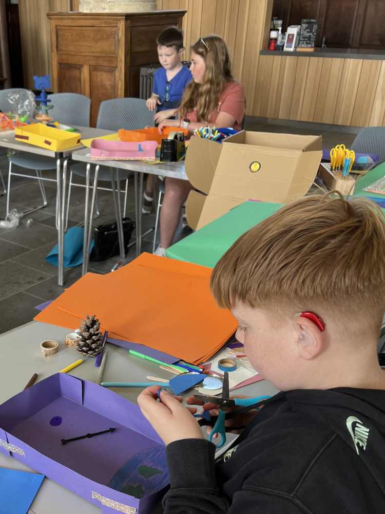 A group of children at a table making crafts.
